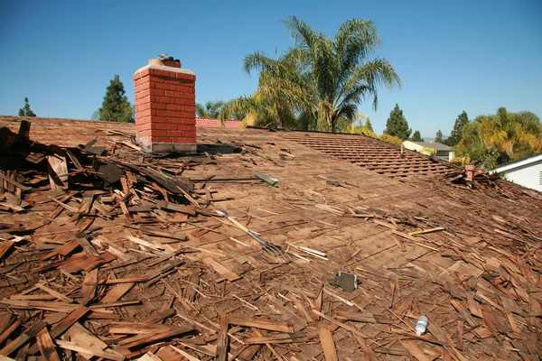 Roof Replacement. Roof repairs old roof replacement with new shingles of a home. Roof repair.  Construction worker installs a new roof. Roofers replacing damaged shingles. Home Roof Repair.