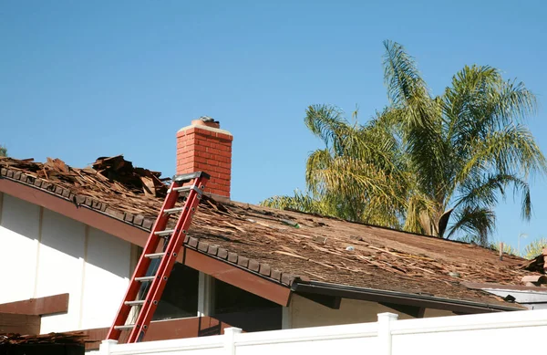 Roof Replacement. Roof repairs old roof replacement with new shingles of a home. Roof repair.  Construction worker installs a new roof. Roofers replacing damaged shingles. Home Roof Repair.