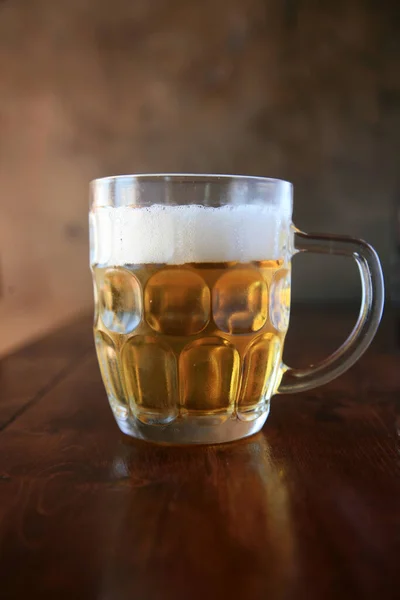 Beer. A glass mug of beer. Beer in a Restaurant. Glass of Beer. Oktoberfest beer. Glass beer mugs full of golden lager with thick frothy heads. Oktoberfest. Beer mug. Big glass of lager beer from Bavaria and Munich Oktoberfest. Festival and Brewery.