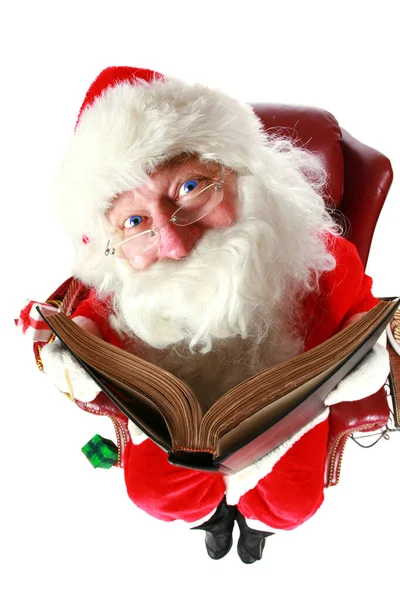 Santa Claus. Santa Claus checks who has been naughty or nice in his big book. isolated on white. room for text.