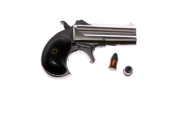 Pistol. Hand Gun. 1887 Remington Arms Company .41 caliber rim fire over and under double derringer pocket pistol. Isolated on white. Room for text. Clipping Path. Derringer Pistol. Gamblers Pistol. Woman's Gun. Self Protection. Antique Derringer 1887