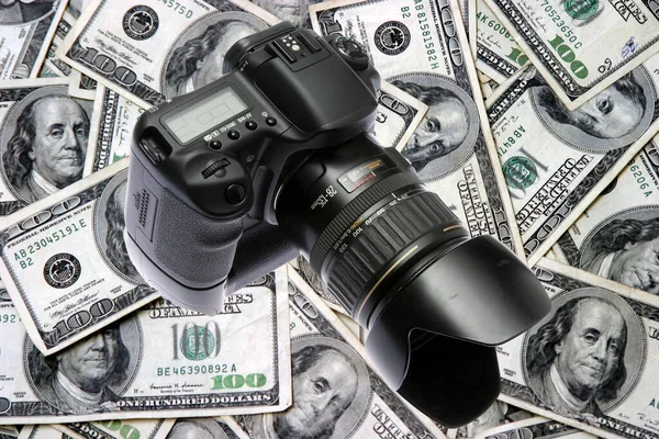 Make Money with your Camera. A Digital Camera and American Money. Make Money with your photography. The Photography business can be a lucrative money making idea. Make Cash taking photos. digital camera and money. photographic equipment.