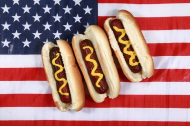 Sosisli sandviç. 4 Temmuz Hot Dog. Barbekü Partisi Yemeği. Amerikan bayrağı taşıyan vatansever bir sosisli sandviç. 4 Temmuz 'da Amerika Birleşik Devletleri' nde Bağımsızlık Günü 'nü kutluyoruz. Bağımsızlık Günü sosislisi. Amerikan Bayrağında Hardallı Üç Sosisli. 