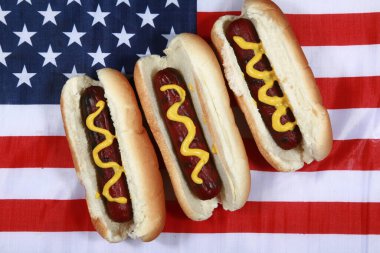 Sosisli sandviç. 4 Temmuz Hot Dog. Barbekü Partisi Yemeği. Amerikan bayrağı taşıyan vatansever bir sosisli sandviç. 4 Temmuz 'da Amerika Birleşik Devletleri' nde Bağımsızlık Günü 'nü kutluyoruz. Bağımsızlık Günü sosislisi. Amerikan Bayrağında Hardallı Üç Sosisli. Çok lezzetli.