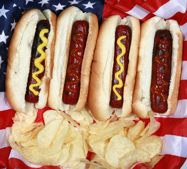 Hot Dog. Forth of July Hot Dog. Barbecue Party Food. American patriotic hot dog with USA flag. Celebrating Independence Day on July 4th in the United States of America.  Independence day hot dog. Hot Dogs the Perfect Food for Holidays and Parties.