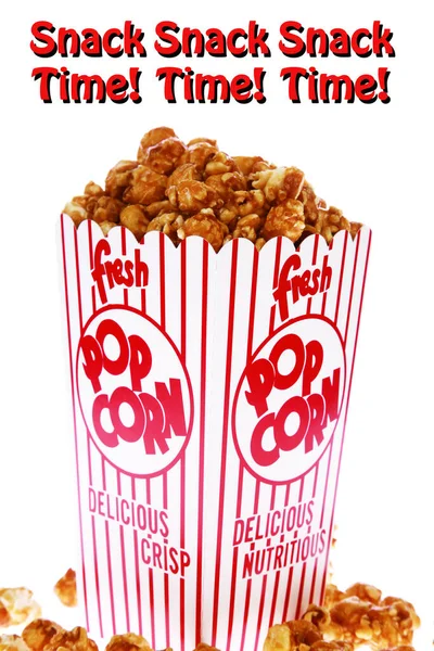 Caramel Popcorn. Caramel popcorn in a decorative paper popcorn cup. Popcorn. Caramel flavored Pop Corn in a Red and White Striped Paper Container. Isolated on white. Room for text. Clipping Path. Caramel Popcorn is enjoyed by happy people world wide.