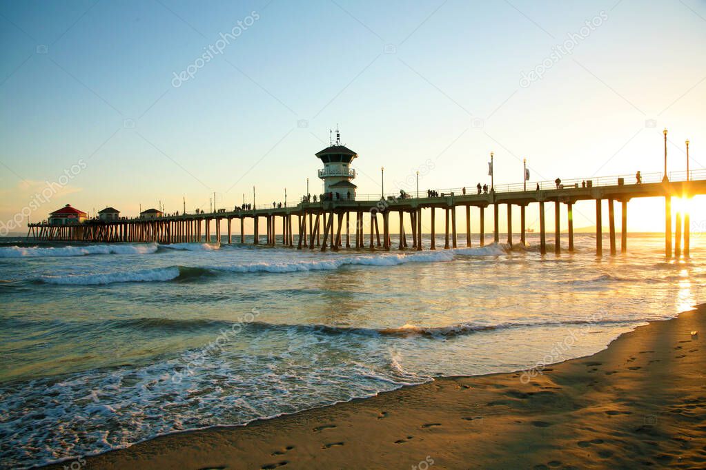 Pier. Huntington Beach Pier. HB Pier. Huntington Beach Pier home of the greatest surfing in the Untied States. Surf City Pier. Orange County California. Sunset over Surf City Huntington Beach Pier. Ocean with the Huntington Beach Pier. Sunset. 