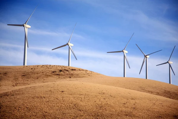 Windmills. Wind Mills. Wind Mill landscape wind turbines. wind mill on a sunny day. Wind turbines generating electricity. Windmills rotating and producing clean energy electric power. Renewable alternative energy. wind generator turbines.