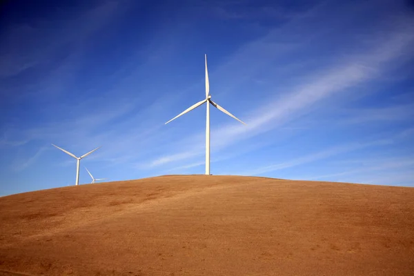 Windmills. Wind Mills. Wind Mill landscape wind turbines. wind mill on a sunny day. Wind turbines generating electricity. Windmills rotating and producing clean energy electric power. Renewable alternative energy. wind generator turbines.