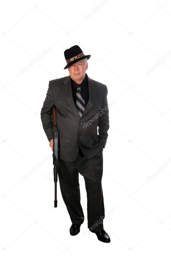 Gangster. A 1920's era gangster in a pin stripe suit holds his Thompson sub machine gun. isolated on white. room for text. Clipping Path. WW11 production .45