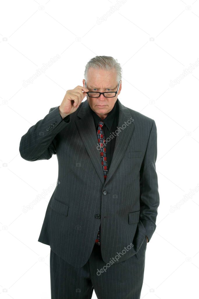 Stern Warning. A Business Man gives a Stern Warning about something important. isolated on white. room for text. clipping path. Businessman gestures STOP with his hand. Businessman looks down over his glasses as he gives a stern warning. 