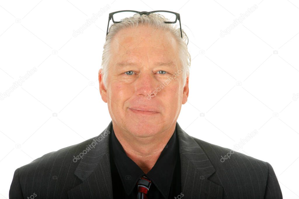 Business Man. A happy business man wearing a suit. Isolated on white. Room for text. Clipping Path. Handsome male fashion model in Grey business suit. a friendly looking man in a suit. Senior businessman looking at camera with a bright smile. 