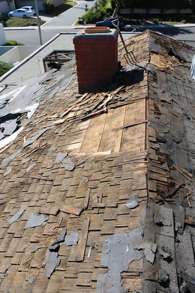Roof Replacement. Roof Repair. Roof construction site. Removal of old roof, replacement with new shingles, equipment and repair. Roofs are a very important part of all housing projects around the world. Demolition and removal of an Old Asphalt roof.