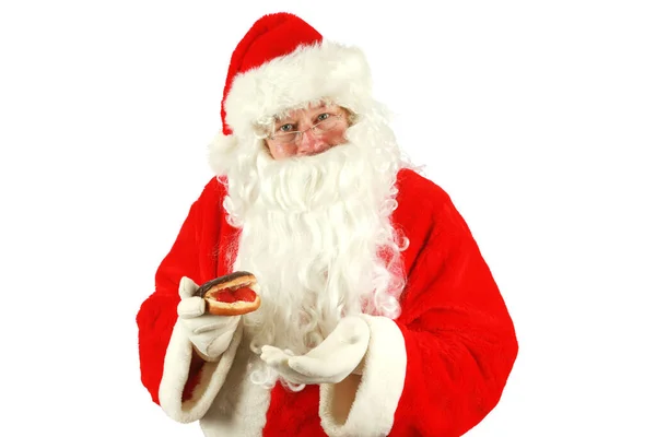 Christmas. Santa Claus. Christmas Donut. Santa Claus loves Donuts. Santa Claus enjoys Donuts left for him on Christmas Eve. Isolated on white. Room for text. Clipping Path. Santa Claus holding donuts. Santa loves donuts and stuff. Merry Christmas.