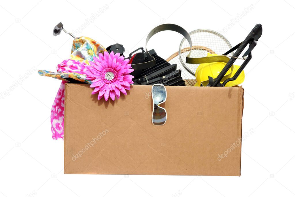 Yard Sale. Tag Sale. Donation. Free. Garage Sale. Cardboard box filled with used items for sale. Isolated on white. Room for text. Clipping Path. Yard Sale items to be sold at a discount in order to make room and make some money at the same time.  