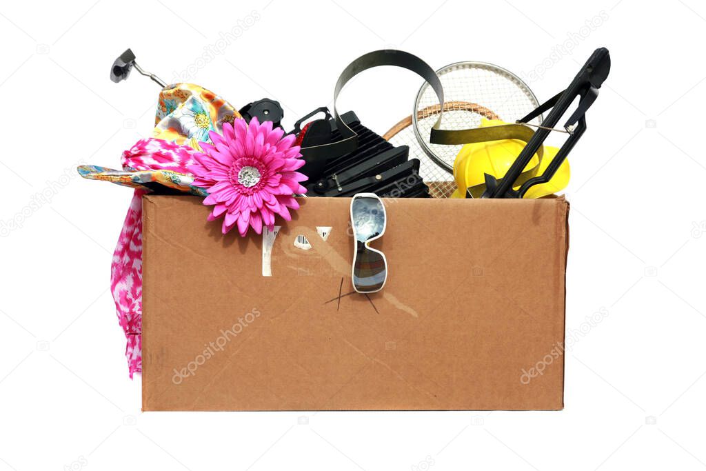 Yard Sale. Tag Sale. Donation. Free. Garage Sale. Cardboard box filled with used items for sale. Isolated on white. Room for text. Clipping Path. Yard Sale items to be sold at a discount in order to make room and make some money at the same time.  