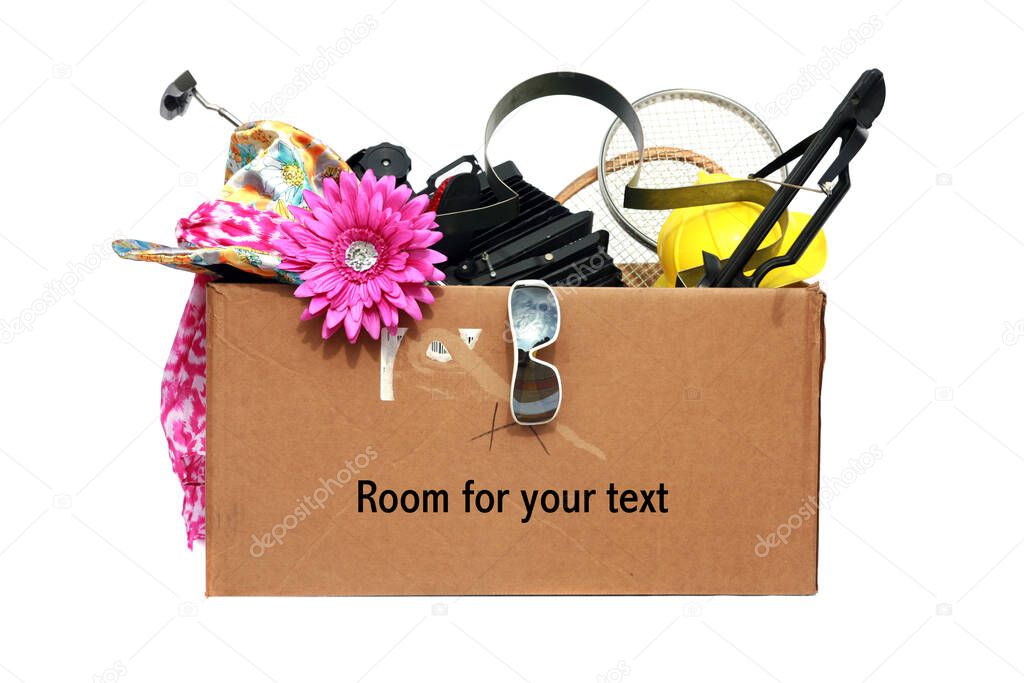Yard Sale. Tag Sale. Donation. Free. Garage Sale. Cardboard box filled with used items for sale. Isolated on white. Room for text. Clipping Path. Yard Sale items to be sold at a discount in order to make room and make some money at the same time.  