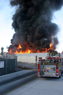 Emergency. Fire. HARBOR GATEWAY, CALIFORNIA- DECEMBER 12, 2015: Fire erupts at recycling yard in Harbor Gateway. Dozens of Fire Trucks arrive to help extinguish an industrial fire, California Dec. 12, 2015.  Editorial. Emergency Services. 