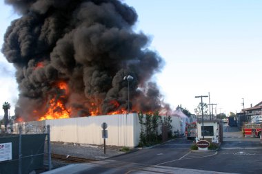 Emergency. Fire. HARBOR GATEWAY, CALIFORNIA- DECEMBER 12, 2015: Fire erupts at recycling yard in Harbor Gateway. Dozens of Fire Trucks arrive to help extinguish an industrial fire, California Dec. 12, 2015.  Editorial. Emergency Services. 