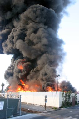 Emergency. Fire. HARBOR GATEWAY, CALIFORNIA- DECEMBER 12, 2015: Fire erupts at recycling yard in Harbor Gateway. Dozens of Fire Trucks arrive to help extinguish an industrial fire, California Dec. 12, 2015.  Editorial. Emergency Services. 