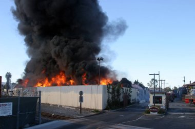 HARBOR GATEWAY, CALIFORNIA- DECEMBER 12, 2015: Fire erupts at recycling yard in Harbor Gateway. Dozens of Fire Trucks arrive to help extinguish an industrial fire, California Dec. 12, 2015. Editorial. 