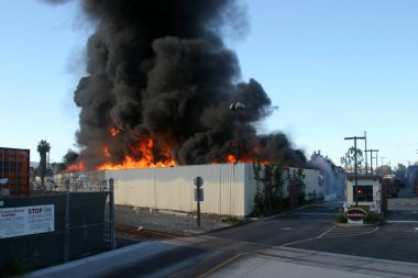 Emergency. Fire. HARBOR GATEWAY, CALIFORNIA- DECEMBER 12, 2015: Fire erupts at recycling yard in Harbor Gateway. Dozens of Fire Trucks arrive to help extinguish an industrial fire, California Dec. 12, 2015.  Editorial. Emergency Services. 