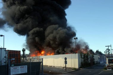 Emergency. Fire. HARBOR GATEWAY, CALIFORNIA- DECEMBER 12, 2015: Fire erupts at recycling yard in Harbor Gateway. Dozens of Fire Trucks arrive to help extinguish an industrial fire, California Dec. 12, 2015.  Editorial. Emergency Services. 