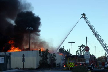 Emergency. Fire. HARBOR GATEWAY, CALIFORNIA- DECEMBER 12, 2015: Fire erupts at recycling yard in Harbor Gateway. Dozens of Fire Trucks arrive to help extinguish an industrial fire, California Dec. 12, 2015.  Editorial. Emergency Services. 