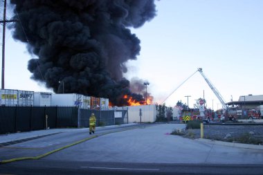 Emergency. Fire. HARBOR GATEWAY, CALIFORNIA- DECEMBER 12, 2015: Fire erupts at recycling yard in Harbor Gateway. Dozens of Fire Trucks arrive to help extinguish an industrial fire, California Dec. 12, 2015.  Editorial. Emergency Services. 