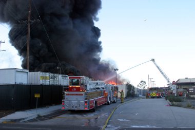 Emergency. Fire. HARBOR GATEWAY, CALIFORNIA- DECEMBER 12, 2015: Fire erupts at recycling yard in Harbor Gateway. Dozens of Fire Trucks arrive to help extinguish an industrial fire, California Dec. 12, 2015.  Editorial. Emergency Services. 