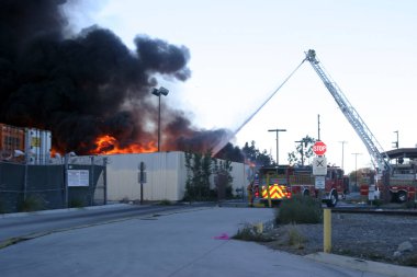 Emergency. Fire. HARBOR GATEWAY, CALIFORNIA- DECEMBER 12, 2015: Fire erupts at recycling yard in Harbor Gateway. Dozens of Fire Trucks arrive to help extinguish an industrial fire, California Dec. 12, 2015.  Editorial. Emergency Services. 