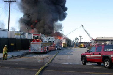 Emergency. Fire. HARBOR GATEWAY, CALIFORNIA- DECEMBER 12, 2015: Fire erupts at recycling yard in Harbor Gateway. Dozens of Fire Trucks arrive to help extinguish an industrial fire, California Dec. 12, 2015.  Editorial. Emergency Services. 