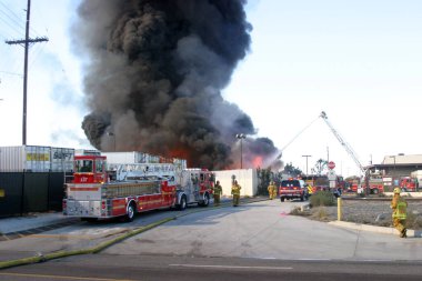 Emergency. Fire. HARBOR GATEWAY, CALIFORNIA- DECEMBER 12, 2015: Fire erupts at recycling yard in Harbor Gateway. Dozens of Fire Trucks arrive to help extinguish an industrial fire, California Dec. 12, 2015.  Editorial. Emergency Services. 