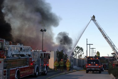 Emergency. Fire. HARBOR GATEWAY, CALIFORNIA- DECEMBER 12, 2015: Fire erupts at recycling yard in Harbor Gateway. Dozens of Fire Trucks arrive to help extinguish an industrial fire, California Dec. 12, 2015.  Editorial. Emergency Services. 