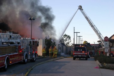 Emergency. Fire. HARBOR GATEWAY, CALIFORNIA- DECEMBER 12, 2015: Fire erupts at recycling yard in Harbor Gateway. Dozens of Fire Trucks arrive to help extinguish an industrial fire, California Dec. 12, 2015.  Editorial. Emergency Services. 