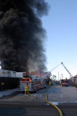 Emergency. Fire. HARBOR GATEWAY, CALIFORNIA- DECEMBER 12, 2015: Fire erupts at recycling yard in Harbor Gateway. Dozens of Fire Trucks arrive to help extinguish an industrial fire, California Dec. 12, 2015.  Editorial. Emergency Services. 