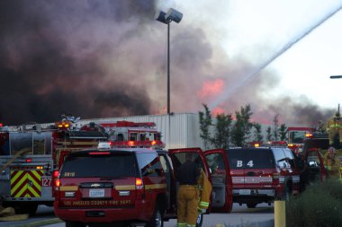 Emergency. Fire. HARBOR GATEWAY, CALIFORNIA- DECEMBER 12, 2015: Fire erupts at recycling yard in Harbor Gateway. Dozens of Fire Trucks arrive to help extinguish an industrial fire, California Dec. 12, 2015.  Editorial. Emergency Services. 