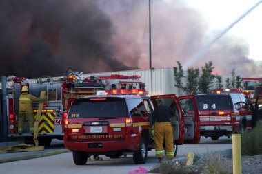 Emergency. Fire. HARBOR GATEWAY, CALIFORNIA- DECEMBER 12, 2015: Fire erupts at recycling yard in Harbor Gateway. Dozens of Fire Trucks arrive to help extinguish an industrial fire, California Dec. 12, 2015.  Editorial. Emergency Services. 