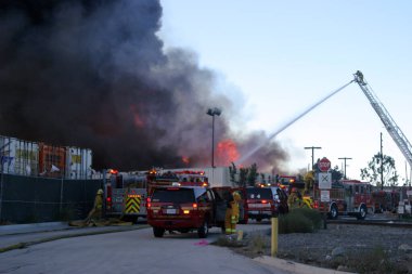 Emergency. Fire. HARBOR GATEWAY, CALIFORNIA- DECEMBER 12, 2015: Fire erupts at recycling yard in Harbor Gateway. Dozens of Fire Trucks arrive to help extinguish an industrial fire, California Dec. 12, 2015.  Editorial. Emergency Services. 