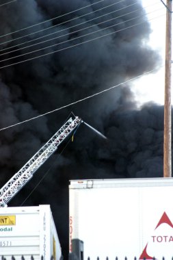 Emergency. Fire. HARBOR GATEWAY, CALIFORNIA- DECEMBER 12, 2015: Fire erupts at recycling yard in Harbor Gateway. Dozens of Fire Trucks arrive to help extinguish an industrial fire, California Dec. 12, 2015.  Editorial. Emergency Services. 
