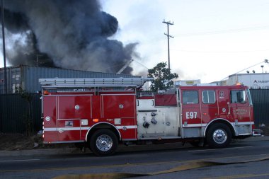 Emergency. Fire. HARBOR GATEWAY, CALIFORNIA- DECEMBER 12, 2015: Fire erupts at recycling yard in Harbor Gateway. Dozens of Fire Trucks arrive to help extinguish an industrial fire, California Dec. 12, 2015.  Editorial. Emergency Services. 