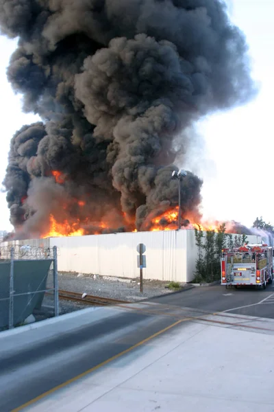 Emergency. Fire. HARBOR GATEWAY, CALIFORNIA- DECEMBER 12, 2015: Fire erupts at recycling yard in Harbor Gateway. Dozens of Fire Trucks arrive to help extinguish an industrial fire, California Dec. 12, 2015.  Editorial. Emergency Services. 
