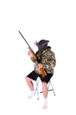 Turkey. Turkey Hunting. Turkey Decoy. Turkey Costume. Turkey Head. shot gun. camouflage. A Hunter dressed in camouflage holds his shot gun and wears a Turkey Decoy on his head. Isolated on white. room for your text.  clipart