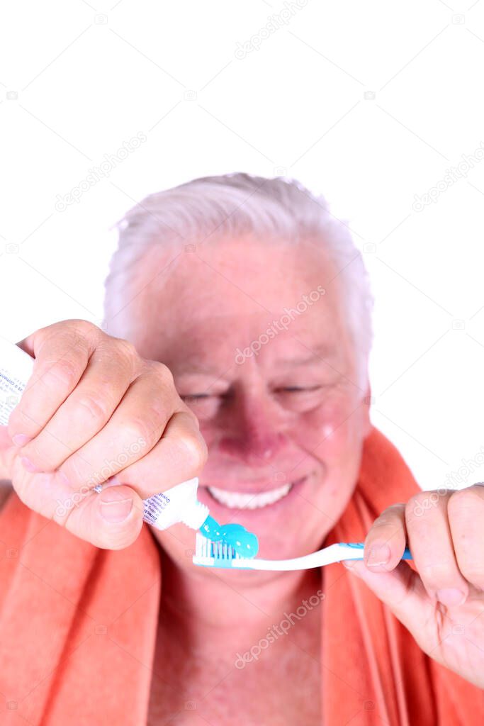 Brushing your teeth. Tooth Brush. Tooth Paste. Dental Care. Hygiene. Man brushing his teeth. carefree guy holding his tooth brush. health and hygiene. handsome man brushing his teeth in morning. relaxed man in orange terry cloth towel. oral hygiene  