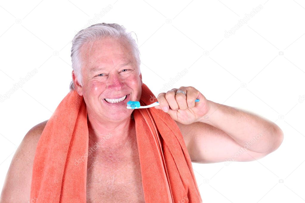 Brushing your teeth. Tooth Brush. Tooth Paste. Dental Care. Hygiene. Man brushing his teeth. carefree guy holding his tooth brush. health and hygiene. handsome man brushing his teeth in morning. relaxed man in orange terry cloth towel. oral hygiene  