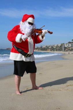 Christmas. Santa Claus. Violin. Fiddle. Santa Claus plays his Violin while at the beach. Santa Claus plays his Fiddle while on vacation on the beach. Santa plays music. Santa Claus in music concert on the beach. Christmas Music. Ho Ho Ho. Merry Xmas. clipart