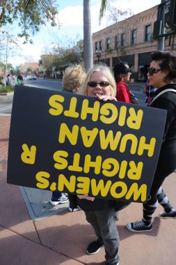 SANTA ANA, CALIFORNIA - JANUARY 21, 2017: People from Orange County carry signs, and wear t-shirts with slogans marched in Santa Ana today for the Orange County Women's March. Editorial. Pink Pussy Hat Protest March. pink pussy hats. 