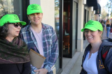 SANTA ANA, CALIFORNIA - JANUARY 21, 2017: People from Orange County carry signs, and wear t-shirts with slogans marched in Santa Ana today for the Orange County Women's March. President Donald J. Trump Protesters. Pink Pussy Hats. Protest Signs. 
