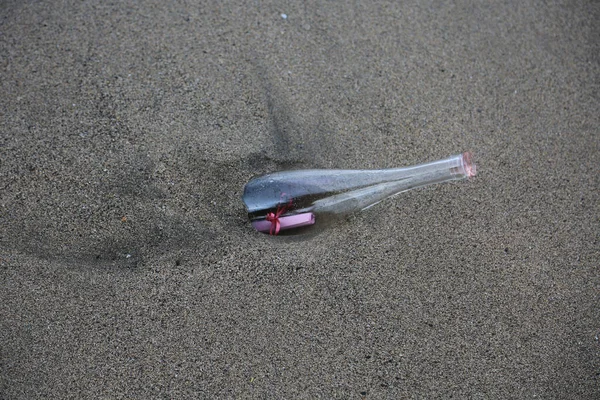Message in a bottle. Message in a Bottle washes up on shore after floating free in the ocean for years. A message inside a glass bottle washed up on a remote beach. SOS. Treasure Map. Pirate Message. I wrote a note. Request for help. Deserted Island.