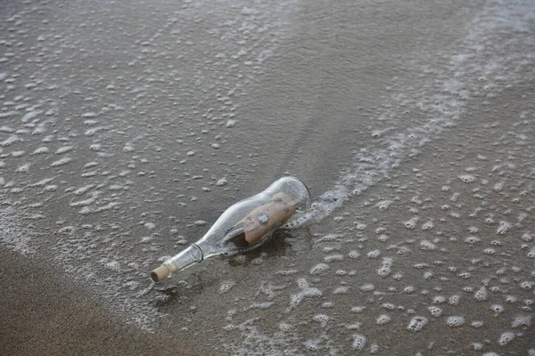 Message in a bottle. Message in a Bottle washes up on shore after floating free in the ocean for years. A message inside a glass bottle washed up on a remote beach. SOS. Treasure Map. Pirate Message. I wrote a note. Request for help. Deserted Island.